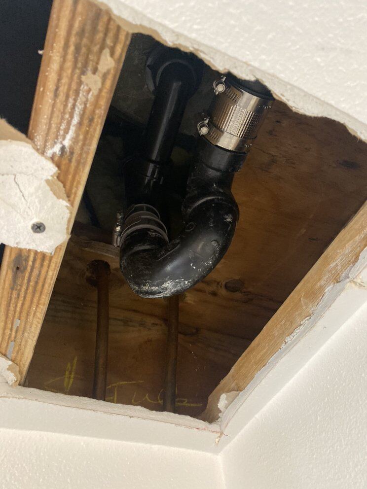 Drain reached through a minimal ceiling access opening